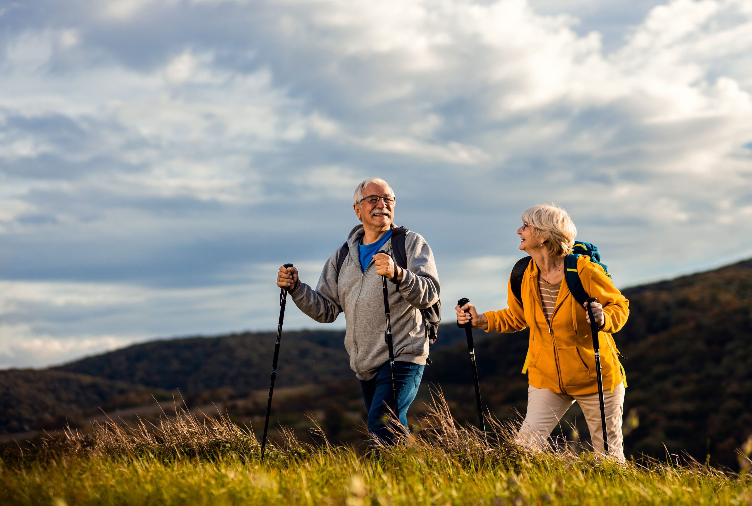 active-senior-couple-with-backpacks-hiking-togethe-2023-09-16-03-29-48-utc-min