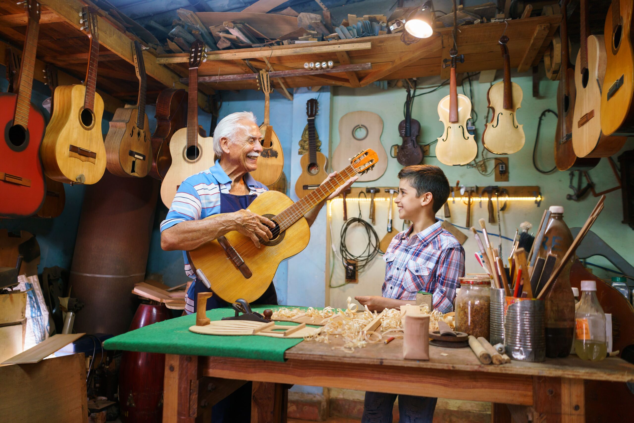 old-man-grandpa-teaching-boy-grandchild-playing-gu-2021-08-26-15-46-10-utc-min